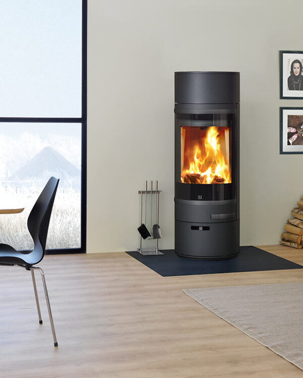 Scan 85-1 wood burning stove in black, in a living room setting- stove lit